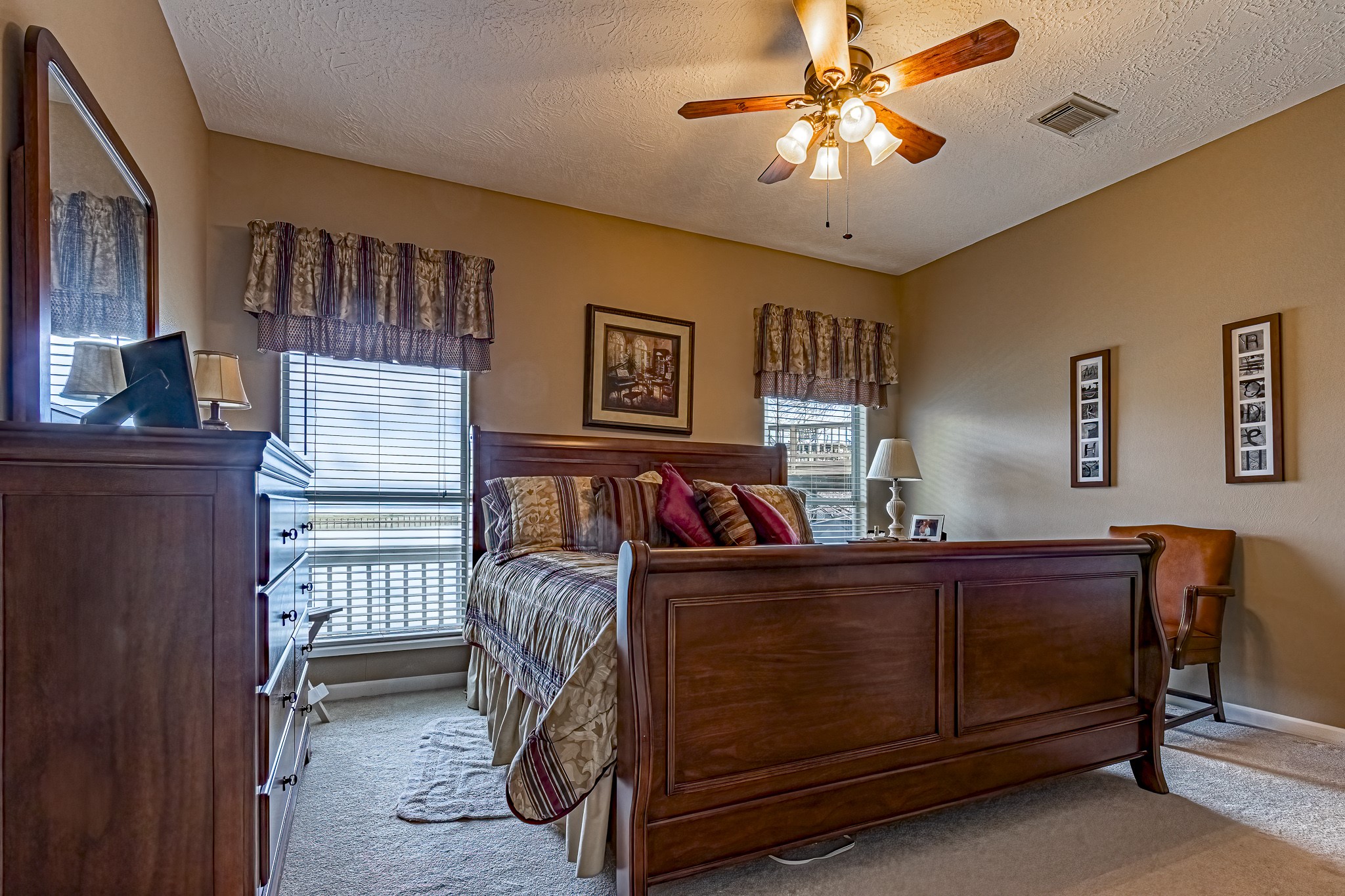 27 Marina Court Coldspring, TX 77331 - Photo 27 of 38 Relaxing primary bedroom retreat with serene natural light, ideal for unwinding after a day on the lake.