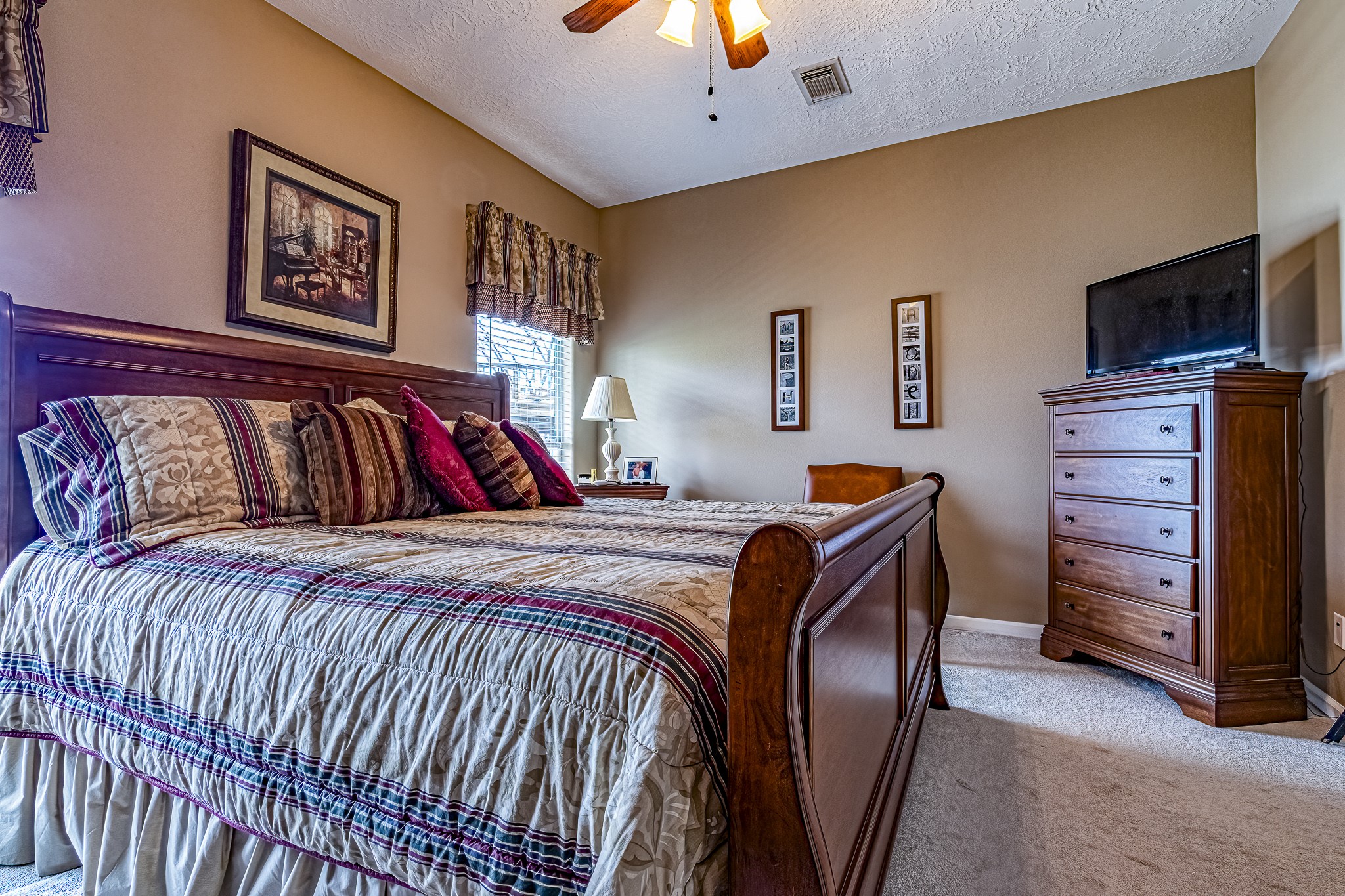 27 Marina Court Coldspring, TX 77331 - Photo 28 of 38 Primary bedroom offering generous space, soft natural light, and a ceiling fan.