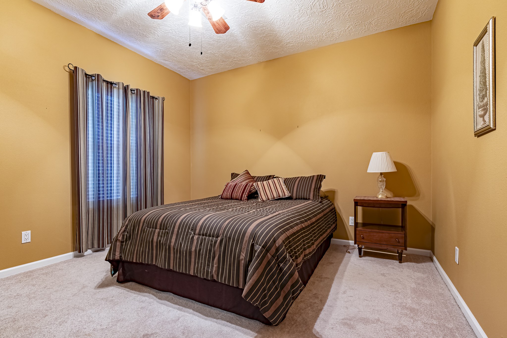 27 Marina Court Coldspring, TX 77331 - Photo 33 of 38 Comfortable guest bedroom with soft natural light and neutral finishes.