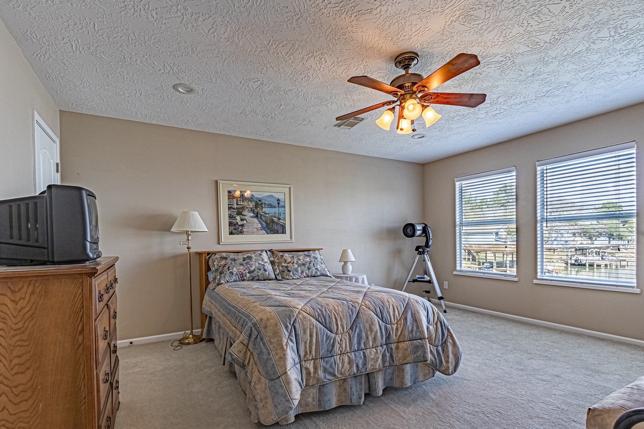 27 Marina Court Coldspring, TX 77331 - Photo 36 of 38 Spacious upstairs bedroom offering privacy, natural light, and lake-area views.