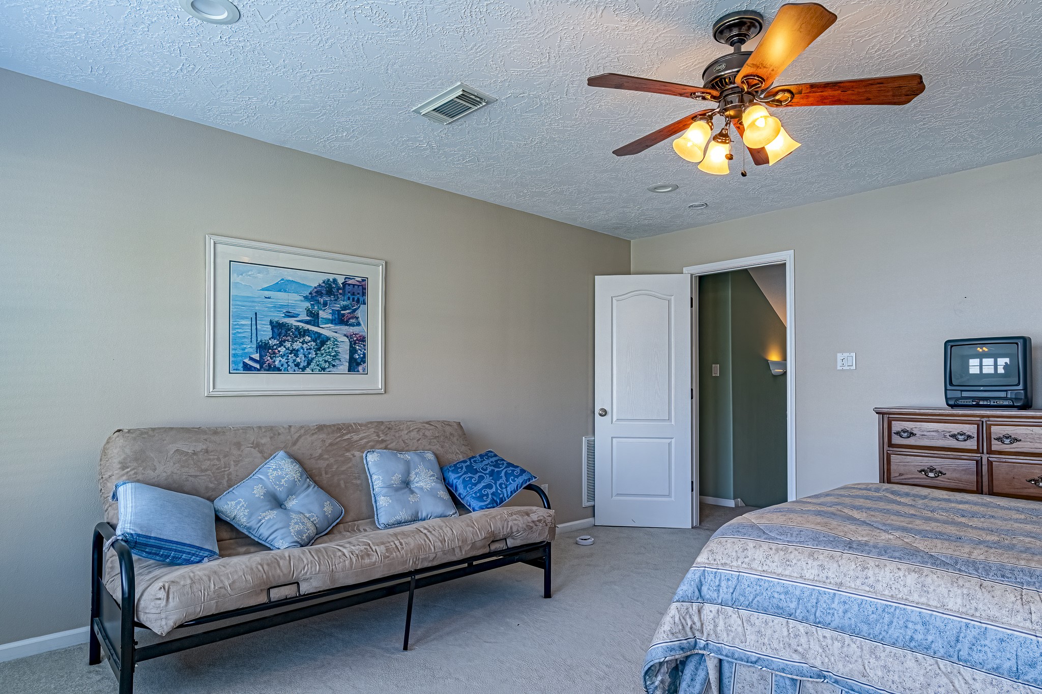 27 Marina Court Coldspring, TX 77331 - Photo 37 of 38 Generously sized upstairs bedroom with ceiling fan and abundant natural light.