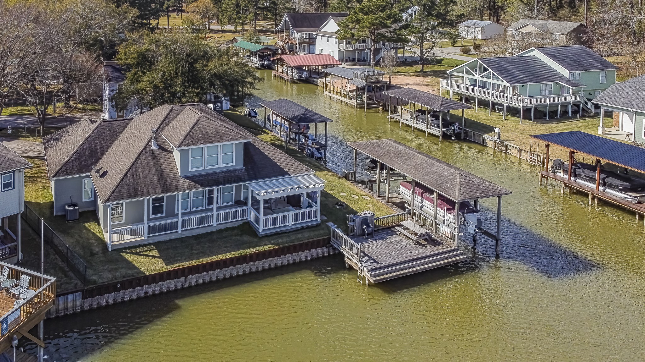 27 Marina Court Coldspring, TX 77331 - Photo 5 of 38 Yard leads directly to the dock and boathouse, offering seamless access to the lake.