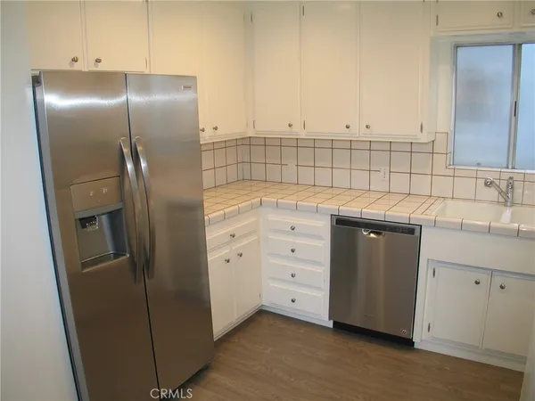 a kitchen with cabinets and stainless steel appliances