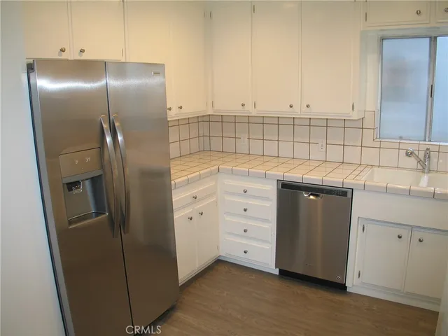 a kitchen with cabinets and stainless steel appliances