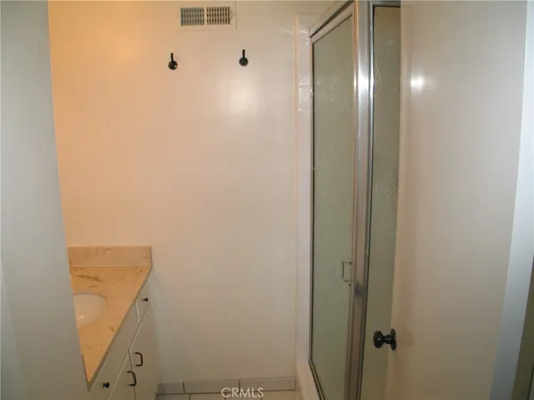 a bathroom with a shower and a mirror