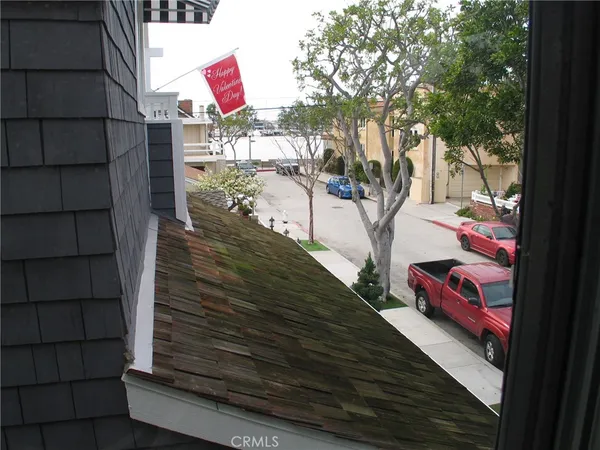 a view of a wooden door and a tree