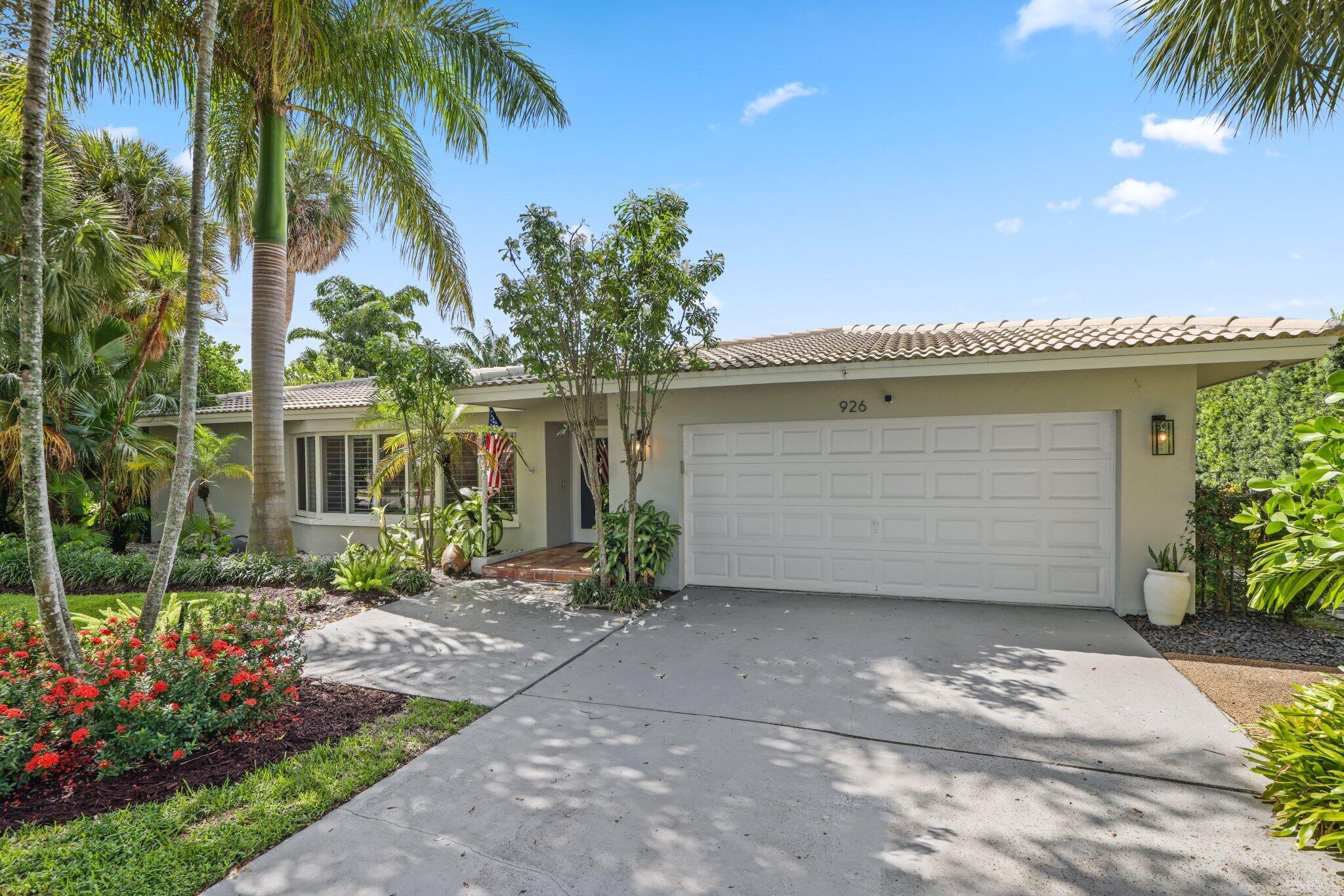 926 Southwest 1st Street Boca Raton, FL 33486 - Photo 5 of 60 a front view of a house with a garden