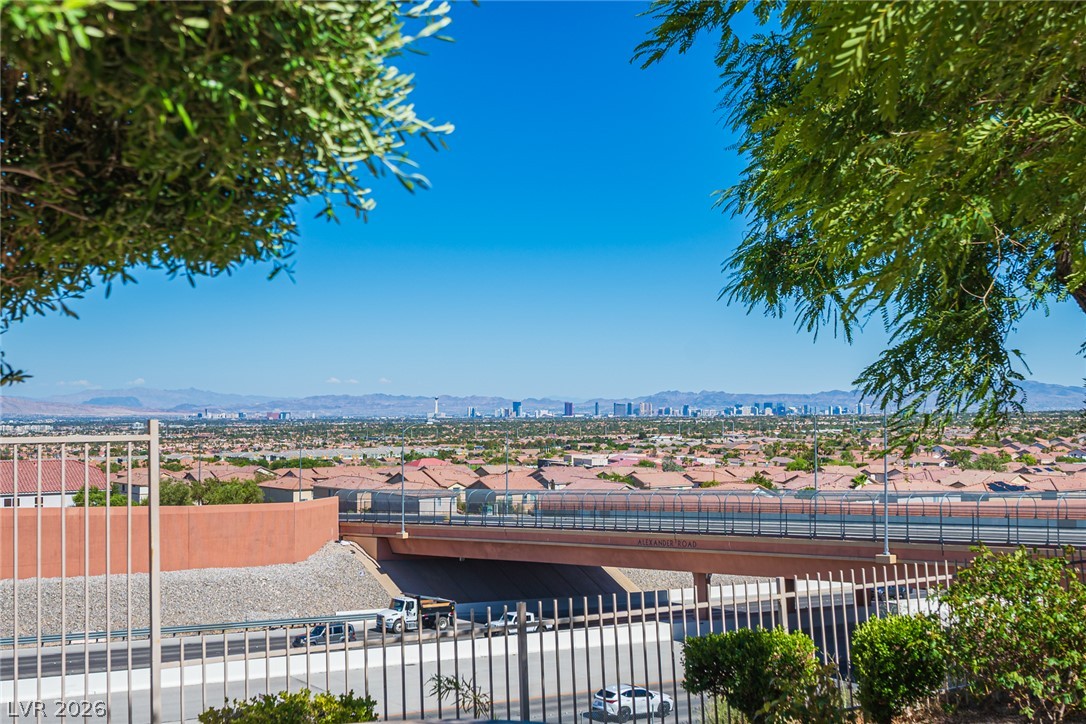 Distant city skyline views stretch across the horizon beneath a clear blue sky.