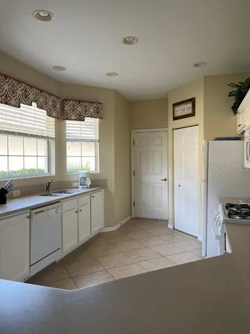 a room with a window and a kitchen