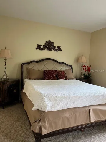 a bedroom with a bed and a lamp