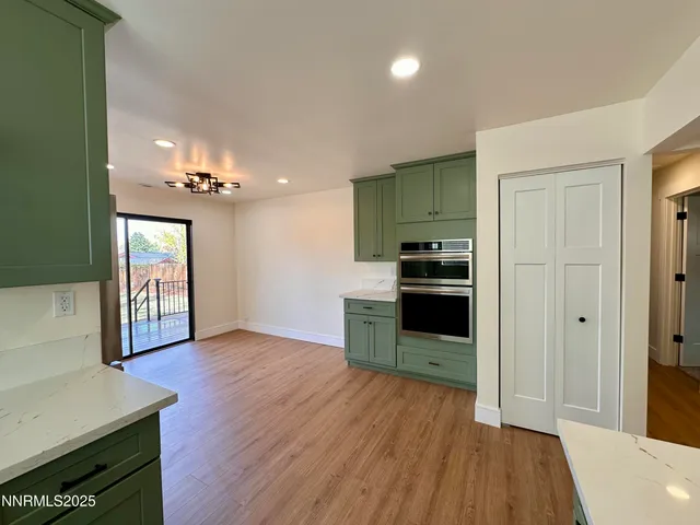 a kitchen with a refrigerator and a stove top oven