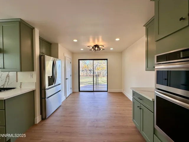 a kitchen with granite countertop stainless steel appliances and wooden cabinets