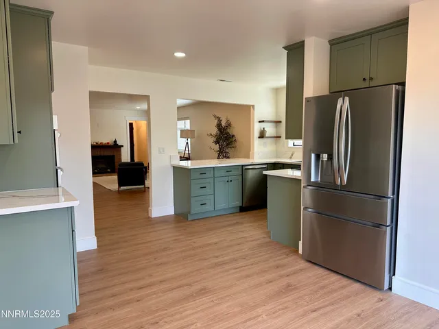 a kitchen with stainless steel appliances granite countertop a refrigerator oven a sink and dishwasher