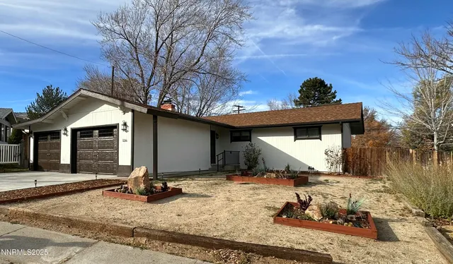 a view of a house with snow on the side of the road