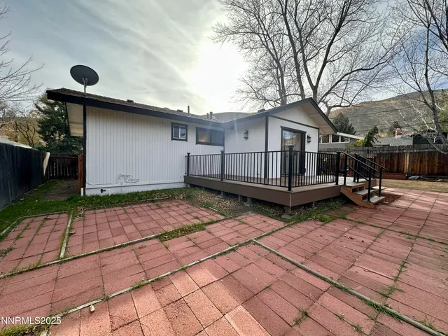 a view of house with backyard and wooden fence