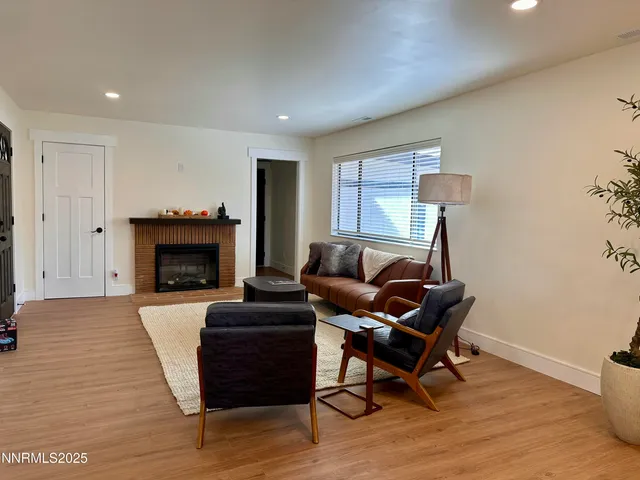 a living room with furniture a fireplace and a table
