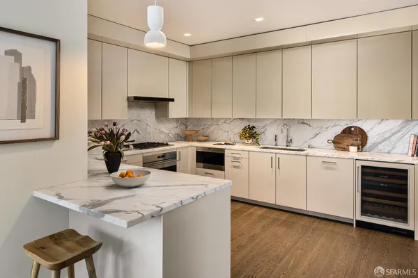 a kitchen with a sink a stove and cabinets