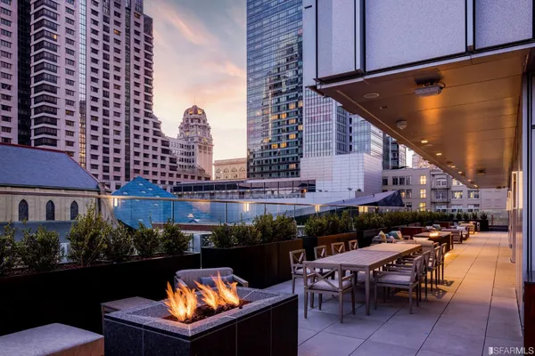 a terrace with outdoor seating and city view