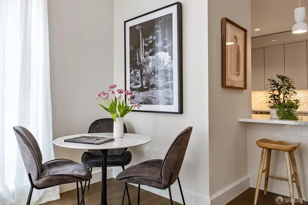 a dining room with furniture and wooden floor