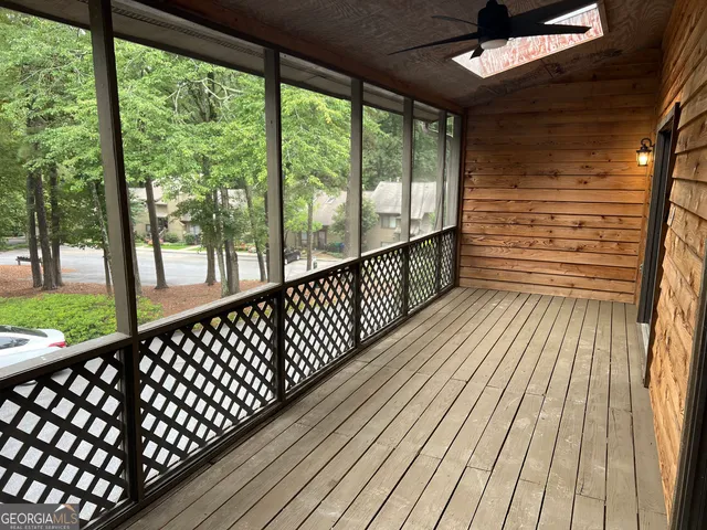 a view of wooden balcony with a large window