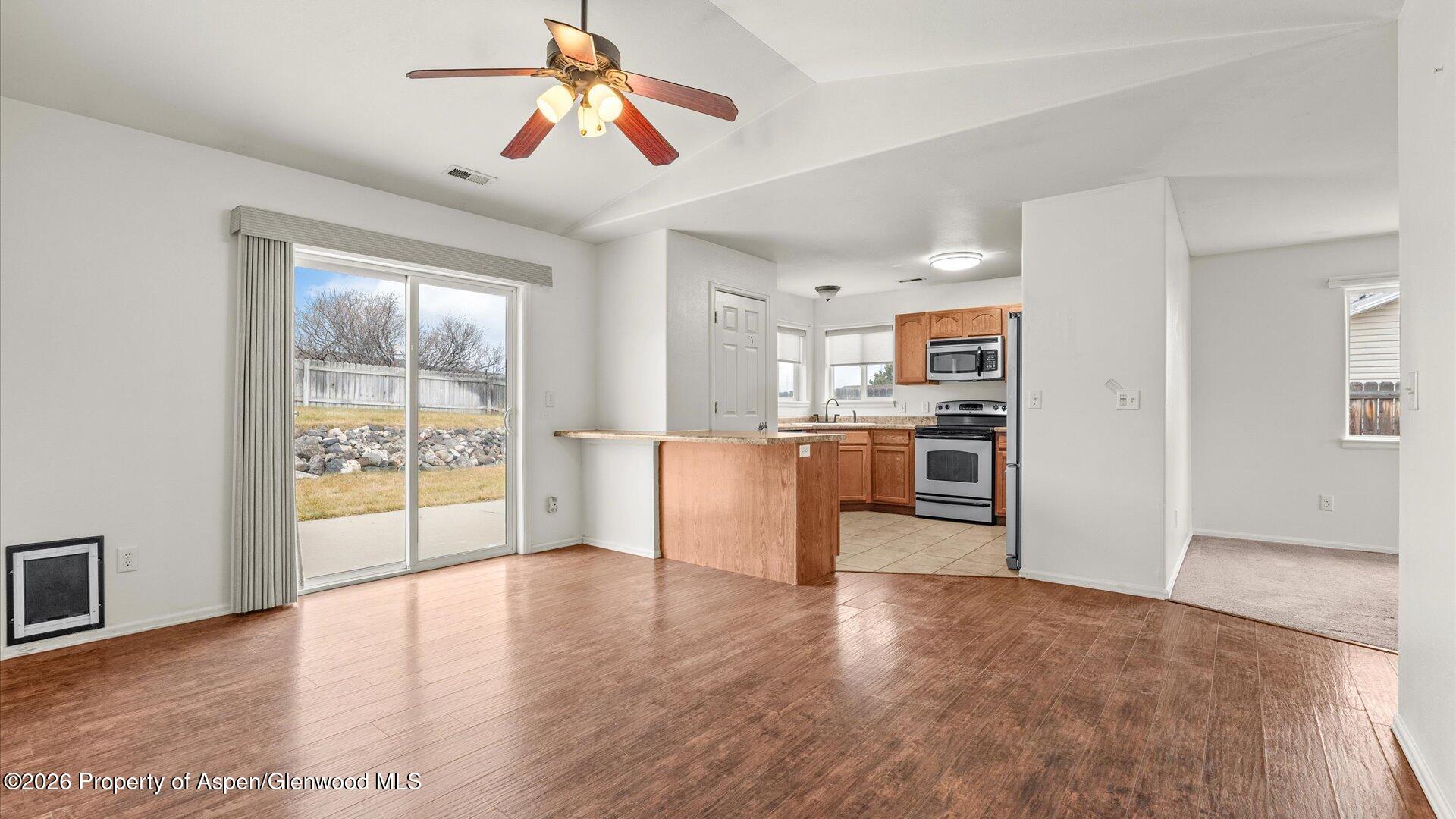188 Cliff View Circle Parachute, CO 81635 - Photo 11 of 36 a view of a kitchen with wooden floor and a window