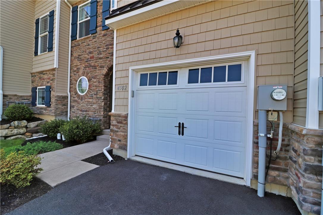 4502 Benjamin Court Emmaus, PA 18049 - Photo 2 of 53 A classic garage door and stone facade welcome residents to this charming home.