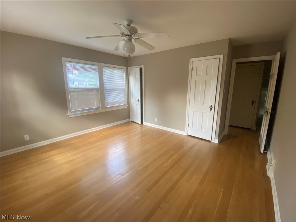 4218 Silsby Road University Heights, OH 44118 - Photo 16 of 27 Hardwood flooring, neutral wall tones, white trim, ceiling fan, and multiple windows