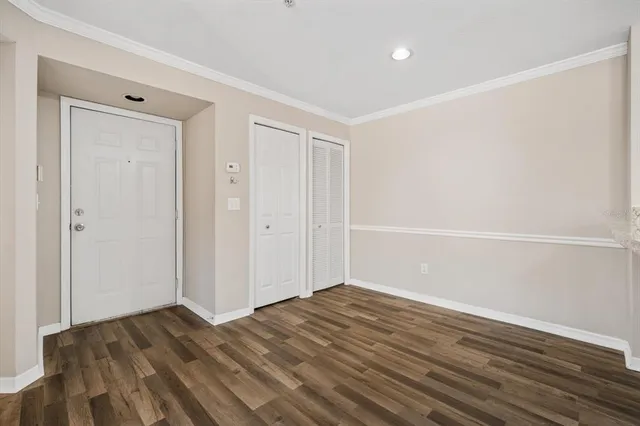 a view of a bedroom with wooden floor and balcony