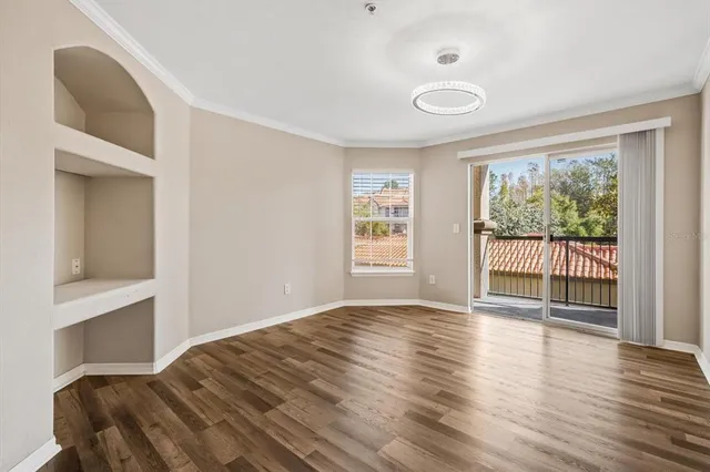 a view of a kitchen with wooden floor and a window