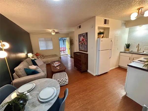 a living room with furniture and kitchen view