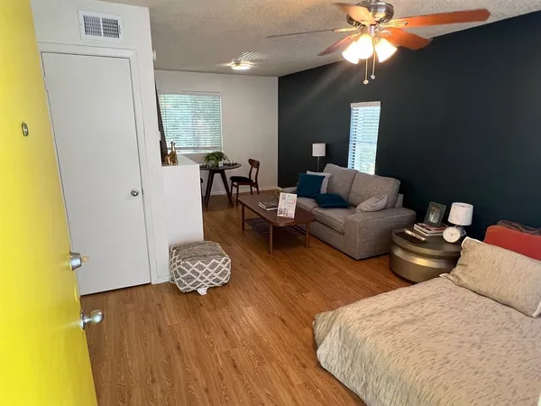 a living room with furniture and a chandelier