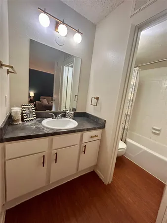 a bathroom with double vanity sink and a mirror