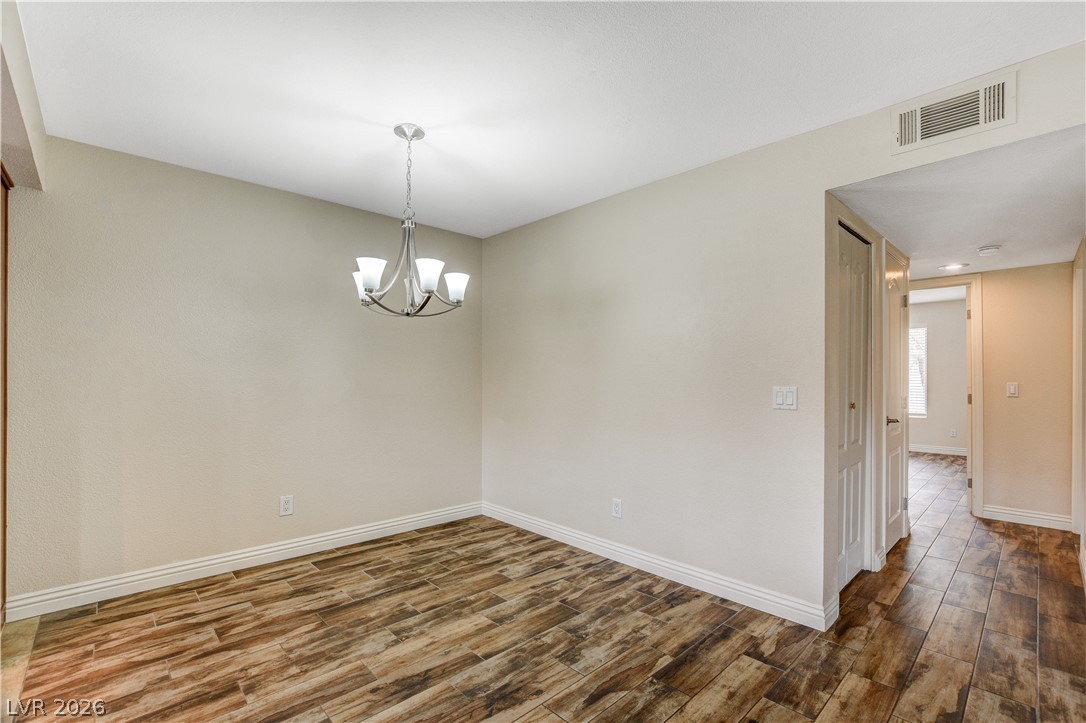 7200 West Pirates Cove Road, Unit 1026 Las Vegas, NV 89145 - Photo 8 of 35 This versatile room features durable flooring and a stylish light fixture.