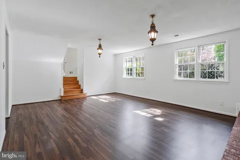 a view of a living room and kitchen with wooden floor