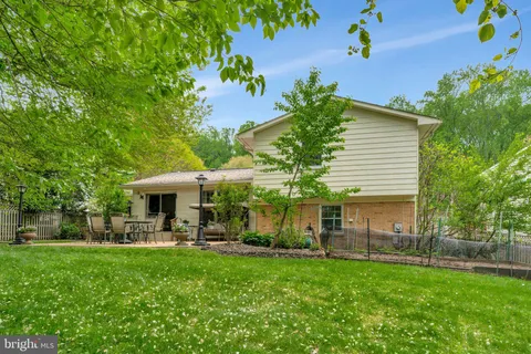 a view of a house with backyard and sitting area