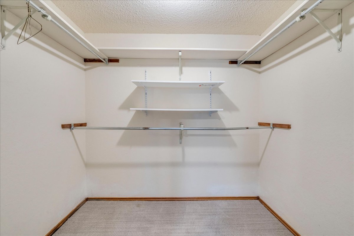 3809 Spicewood Springs Road, Unit 127 Austin, TX 78759 - Photo 16 of 29 Functional shelving and hanging rods create an organized closet space.