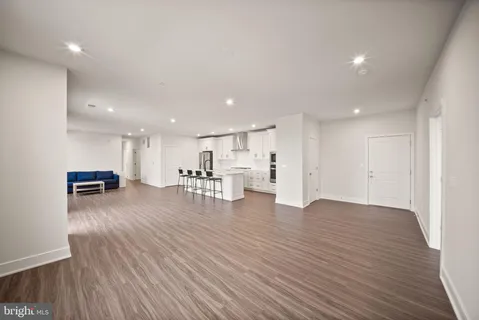a kitchen with stainless steel appliances a sink a stove top oven a counter space and cabinets