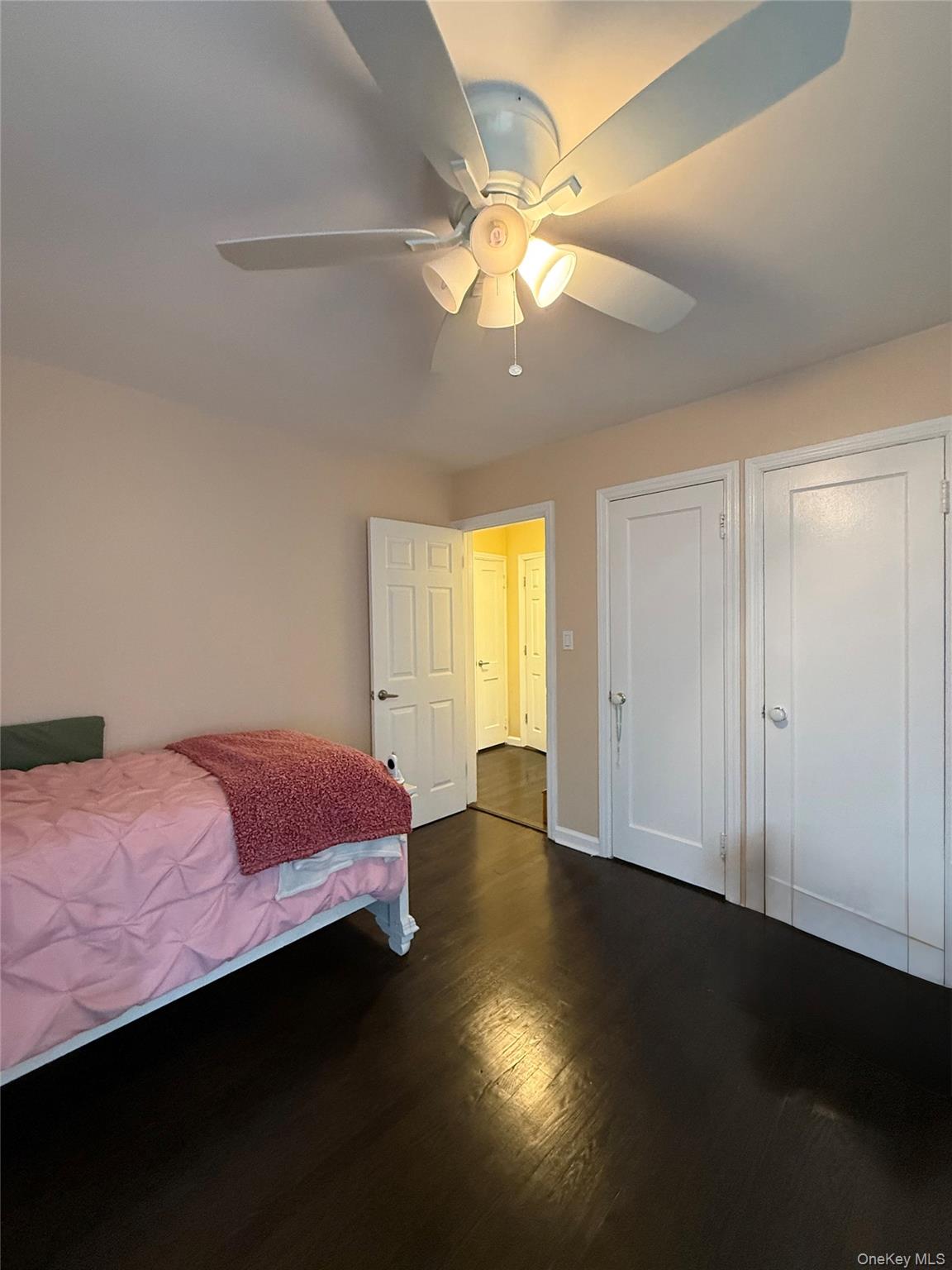 57 Laurel Road Lindenhurst, NY 11757 - Photo 18 of 24 a bedroom with a bed and wooden floor