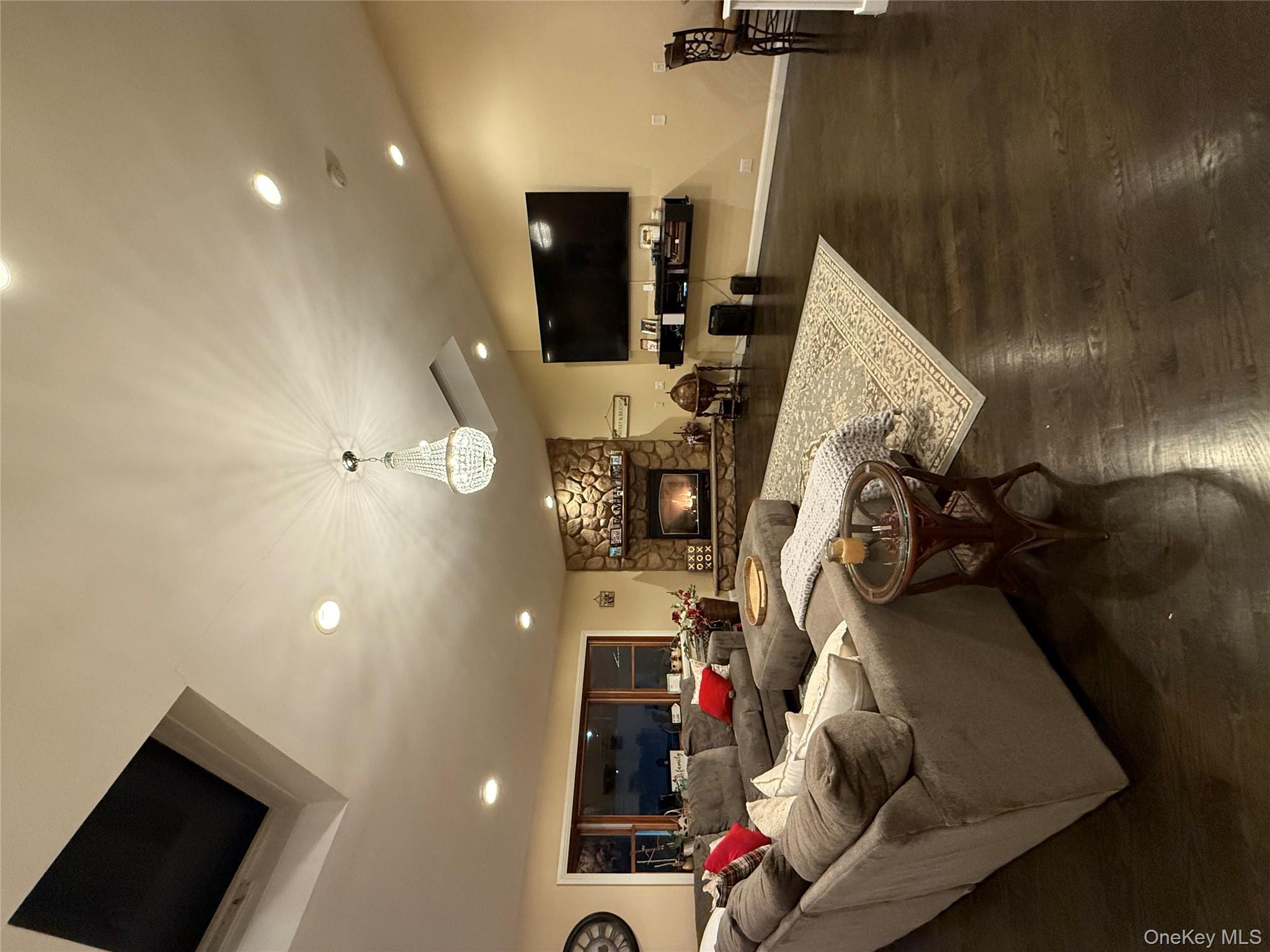 57 Laurel Road Lindenhurst, NY 11757 - Photo 2 of 24 a living room with furniture and a flat screen tv