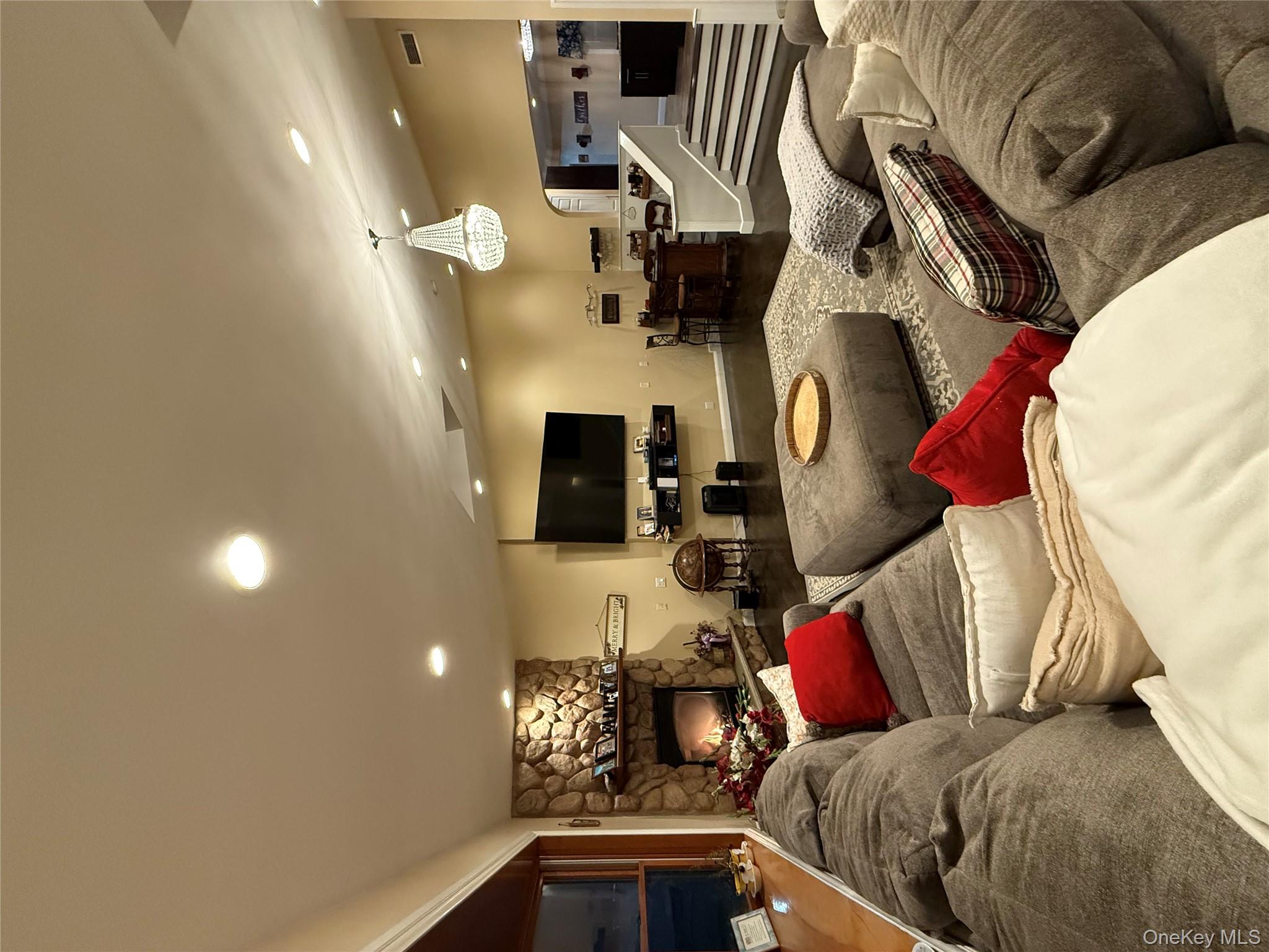 57 Laurel Road Lindenhurst, NY 11757 - Photo 3 of 24 a living room with furniture and a flat screen tv