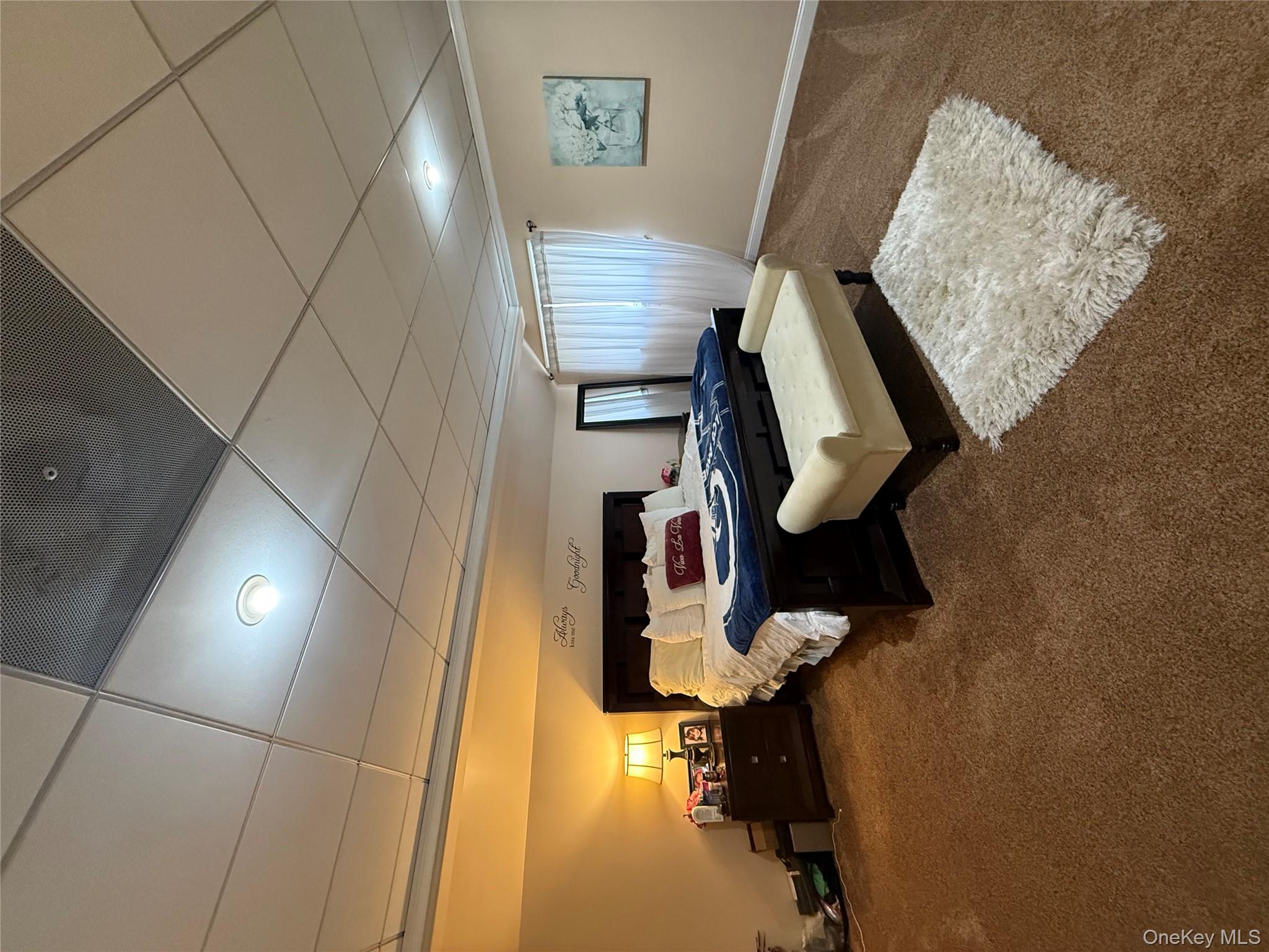 57 Laurel Road Lindenhurst, NY 11757 - Photo 5 of 24 a bedroom with furniture and a couch