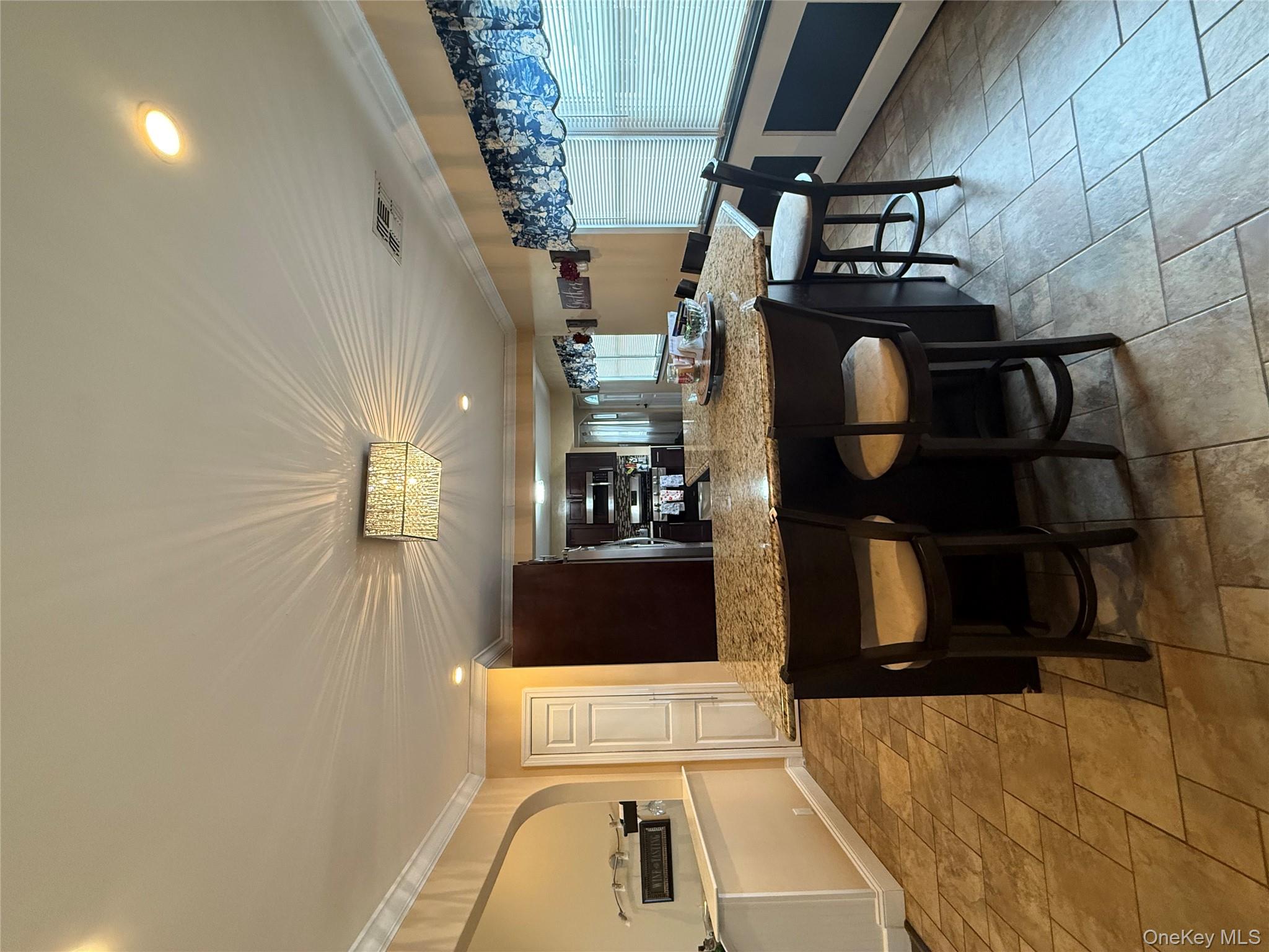 57 Laurel Road Lindenhurst, NY 11757 - Photo 9 of 24 a kitchen with a table and chairs in it