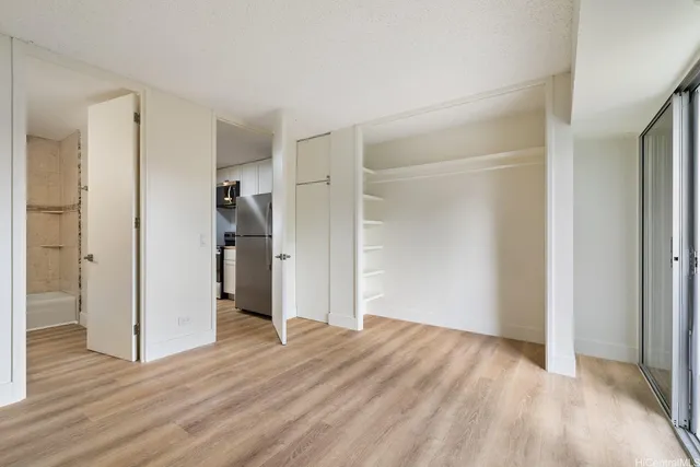 a view of empty room with wooden floor