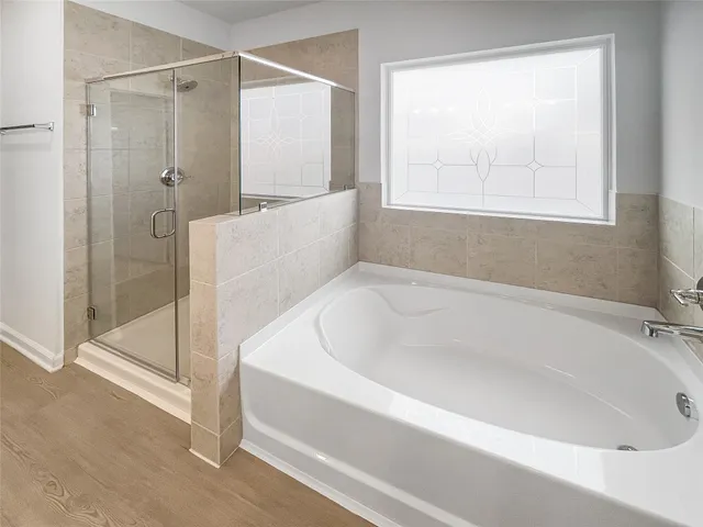 a white bath tub sitting next to a shower