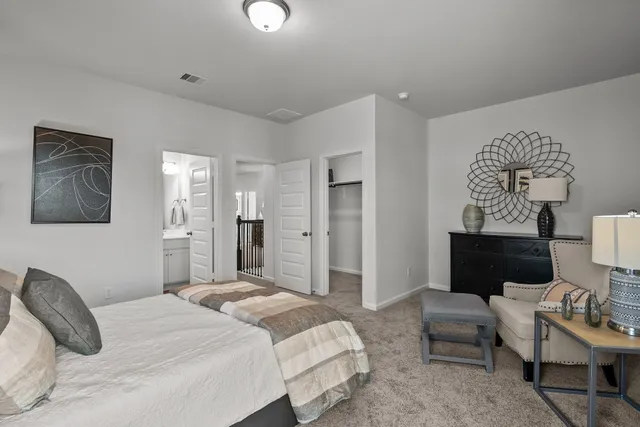 a bedroom with a bed and a couch