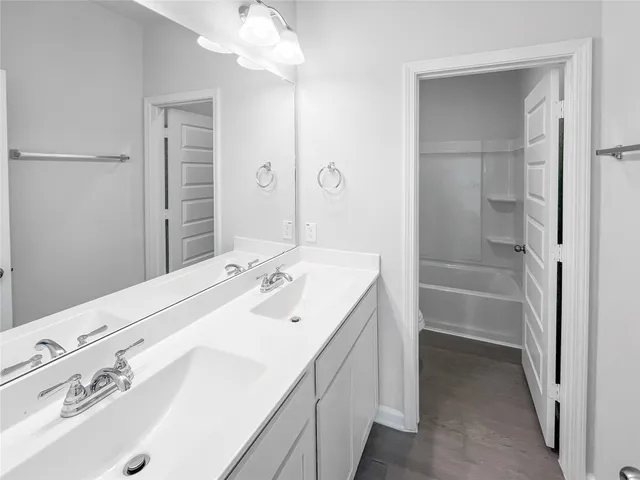 a bathroom with a sink a vanity and a mirror