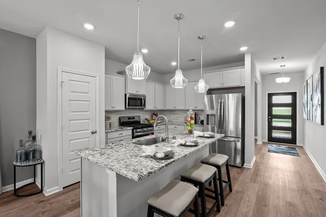 a kitchen with cabinets and stainless steel appliances