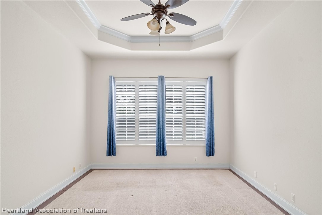 5224 Haw Branch Road Sebring, FL 33875 - Photo 17 of 40 an empty room with windows and ceiling fan