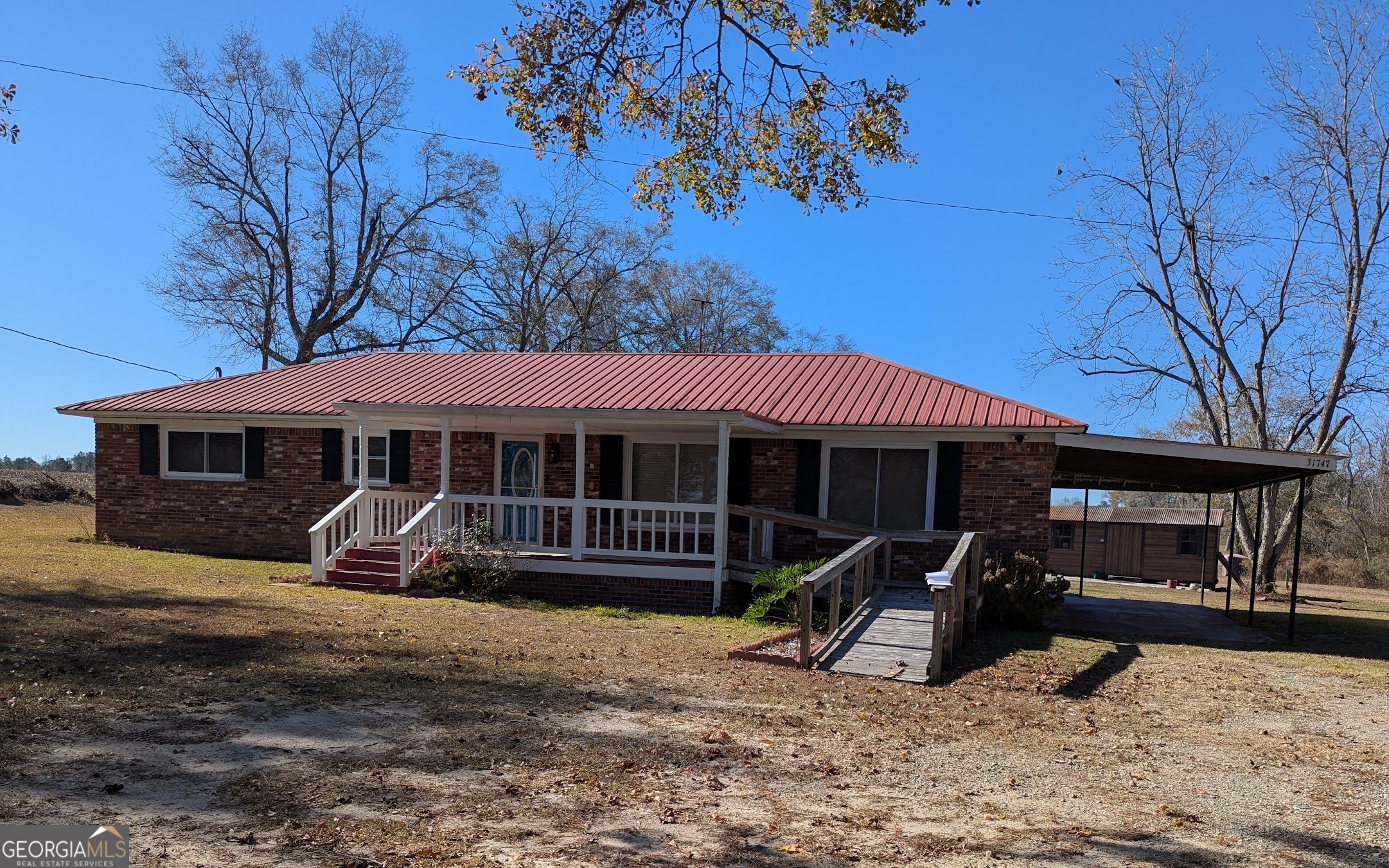 a view of a house with backyard porch and sitting area