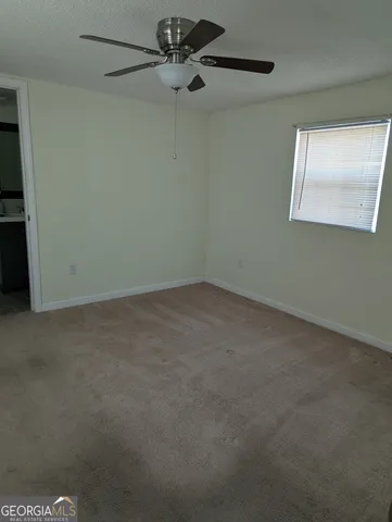 an empty room with a fan